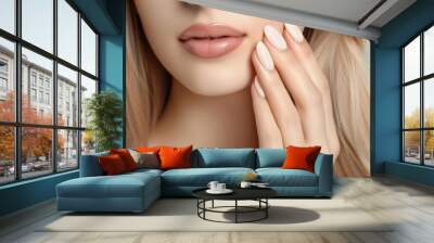 Light nude manicure. Hand near face, lips close up Wall mural