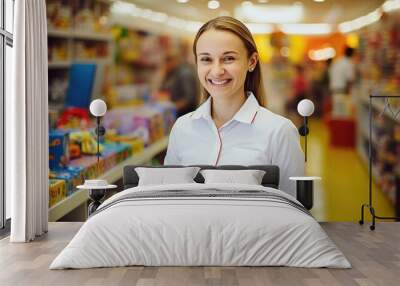 Smiling female saleswoman in a toy store. Consultant in a children toy shop Wall mural