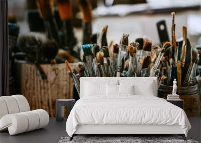 Table with brushes and tools in an art workshop. Background. Wall mural