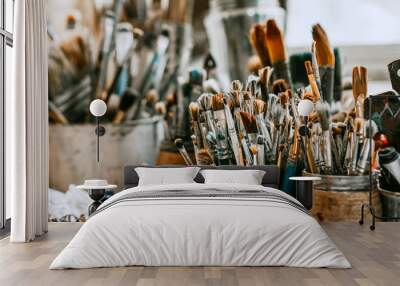 Table with brushes and tools in an art workshop. Background. Wall mural