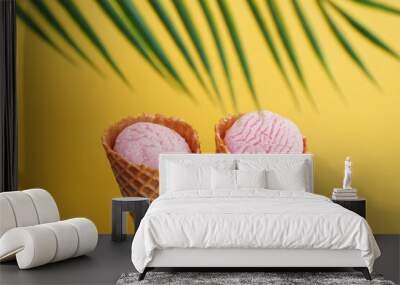 Two strawberry ice creams in a cone on a yellow background. Tropical leaf Wall mural