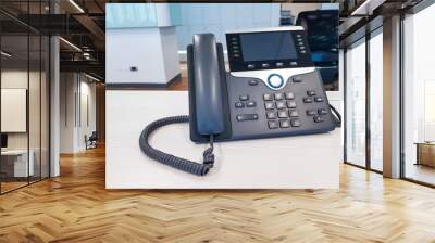 IP phone device on work office table desk background. Communication Technology to connect and call for business use in digital era in corporate company use. Professional device for call, conference. Wall mural