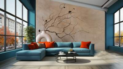 Dry branch of in round modern white vase against beige wall Wall mural