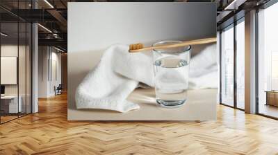 Glass with drinking water under bamboo toothbrush with soft fiber for sensitive gums and teeth Wall mural