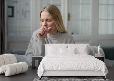 sick female coughing and has viral infection Wall mural