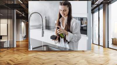 Smiing woman housewife cleaning dishes in sink Wall mural