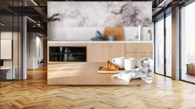 wooden table with mugs of tea and fresh pastry in modern kitchen Wall mural