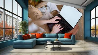 Young adult woman using modern laptop computer at home Wall mural