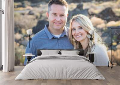 Beautiful Middle-Aged Couple portrait outdoors. Smiling and looking at the camera with a happy expression on their faces as they hold each other with love Wall mural