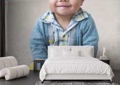 Beautiful smiling diverse baby boy portrait. Full length photo of an adorable child sitting indoors Wall mural