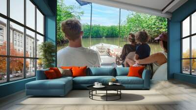 View from behind of a Family on a wildlife estuary boat tour in Costa Rica. Exploring the Tamarindo estuary and river area looking for wildlife and the mangrove forests. Costa Rican Travel photo Wall mural