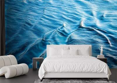 Blue water with ripples on the surface. Defocus blurred transparent blue colored clear calm water surface texture with splashes and bubbles. Water waves with shining pattern texture background. Wall mural