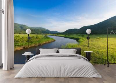 mountain with river clean and green field Wall mural