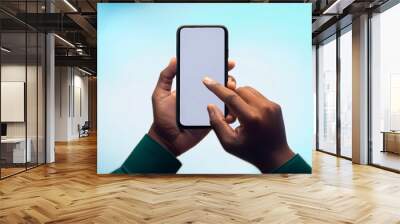 Close-up of a businessman hand holding a smartphone white screen is blank the background. Mockup  Wall mural