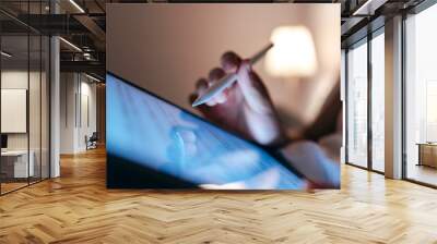 Close-up woman hand holding digital tablet at night Wall mural