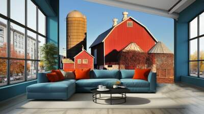 On a bright winter day, a red barn, silos and empty storage cribs await spring in front of a farm in the northeastern community of South Elgin, Illinois.  Wall mural