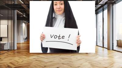 Young nun showing vote sign on white background Wall mural