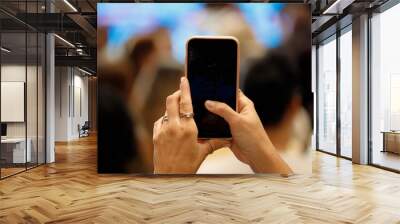 woman holding cell phone at an event in Rio de Janeiro. Wall mural