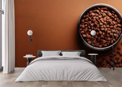 A bowl filled with small brown kibble on a matching background, suggesting pet food. Wall mural