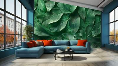 A close-up view of various green leaves arranged artistically, showcasing texture and depth. Wall mural