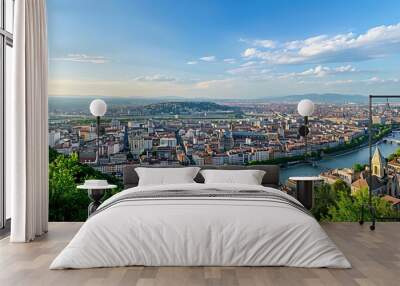 Panoramic view of a cityscape with rivers, buildings, and greenery under a blue sky. Wall mural