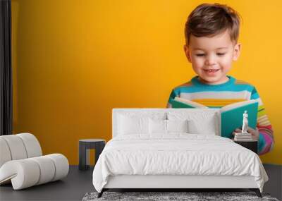 Young boy in striped shirt with book, intellectual child, reading theme Wall mural