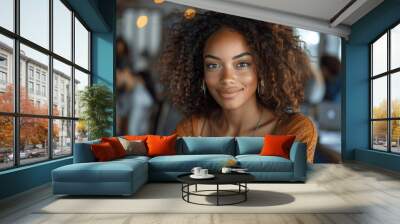 Young Woman Smiling Indoors With Curly Hair And Hoop Earrings Wall mural