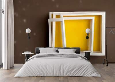 A minimalist art piece consisting of two white frames with a yellow interior, set against a dark background with a subtle pattern of white dots Wall mural