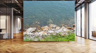 The rocky shore of the sea. Turquoise beautiful water. Wall mural