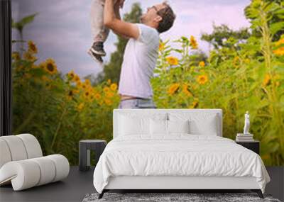 happy fatherhood in the sunflower field. son and father with glasses Wall mural