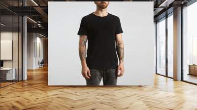 brutal attractive bearded biker man with tattooed hands poses in black blank t-shirt from premium th Wall mural