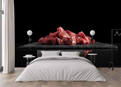 Pieces of raw fresh meat isolated on black on stone board mirrored side view Wall mural