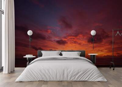 Nature background. Shot of Landscape amazing of red sky sunset in the sea with red clouds background. Travel concept. Wall mural