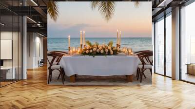 A Table Set up for a romantic meal on the beach with lanterns and chairs and flowers with palms and sky and sea in the background Wall mural