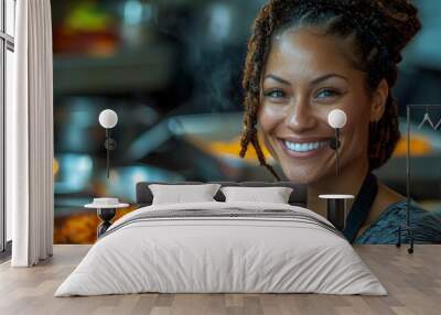 A smiling woman in an apron stands in front of a food display, showcasing her culinary skills. Wall mural