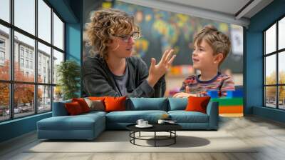 A teacher and student using sign language in a special education setting Wall mural