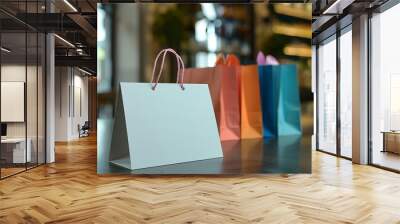 Blank gift card on a retail counter with colorful bags in the background Wall mural