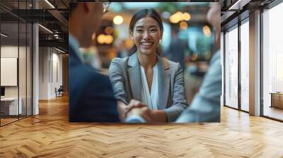 Business professionals shaking hands after a successful meeting Wall mural