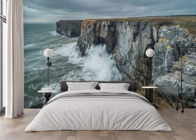 Coastal cliff with waves crashing against the rocks, dramatic seascape Wall mural