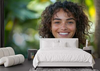 Portrait of a Smiling Woman with Curly Brown Hair Wall mural