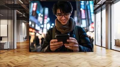 Portrait Young Using Smartphone on City Street at Night Wall mural