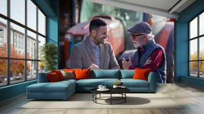 Bank agent talking to farmer on farm about contract Wall mural