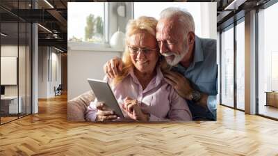 Elderly couple with tablet Wall mural