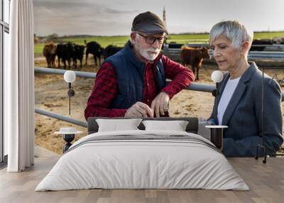 Farmer and business woman on cow farm Wall mural