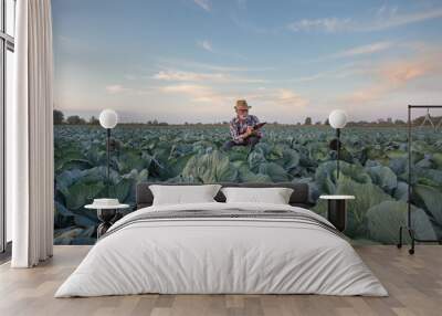 Farmer with notebook in cabbage field Wall mural