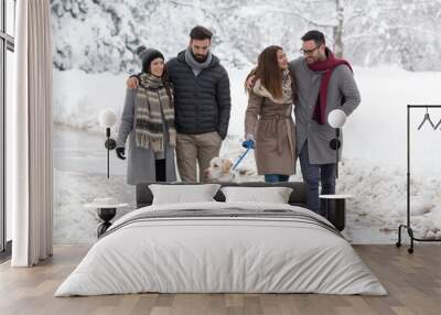 Friends walking dog in park on snow Wall mural