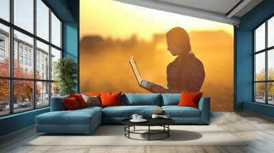 Woman with laptop at sunset Wall mural