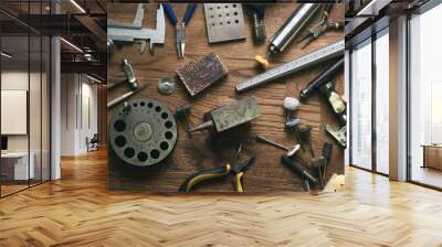 Top view jewelry maker workbench with tools on table. Equipment and tools of a goldsmith on wooden working desk inside a workshop. Wall mural