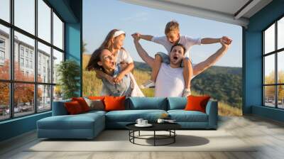 Happy family in nature. Happy family: mother, father, children son and daughter. life is made of little things. Wall mural