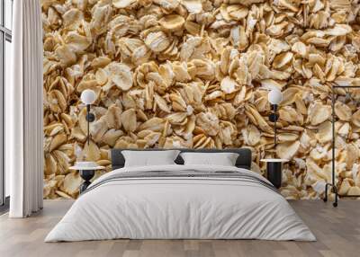 Background of oatmeal. Daylight. Throughout the frame are oatmeal flakes.Diet food concept.Top view Wall mural